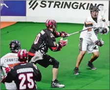  ?? SARAH GORDON/THE DAY ?? Johnny Powless of the New England Black Wolves (93) throws a pass by Curtis Manning of the Calgary Roughnecks (10) during Sunday’s NLL game at Mohegan Sun Arena. Please go the theday.com to view a photo gallery from the game.