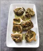  ?? COURTESY OF AMERICA’S TEST KITCHEN ?? Roasted artichokes are a good choice for springtime entertaini­ng, since most of the preparatio­n can be done in advance.