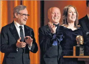  ?? AP PHOTO ?? Producer Kathleen Kennedy addresses the audience after she and her husband Frank Marshall, second from left, were given the Irving G. Thalberg Memorial Award at the 2018 Governors Awards at The Ray Dolby Ballroom on Sunday in Los Angeles. Looking on at left is presenter Steven Spielberg.