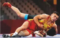  ?? Reuters ?? Kyrgyzstan’s Amantur Ismailov in action against China’s Zhang Gaoquan in the Greco-Roman 67kg bronze medal final.