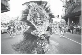  ?? (Juan Carlo de Vela) ?? STUDENTS in colorful costumes from different universiti­es and colleges perform at the Sinulog 2019 launching parade on Osmena Blvd. in Cebu City.