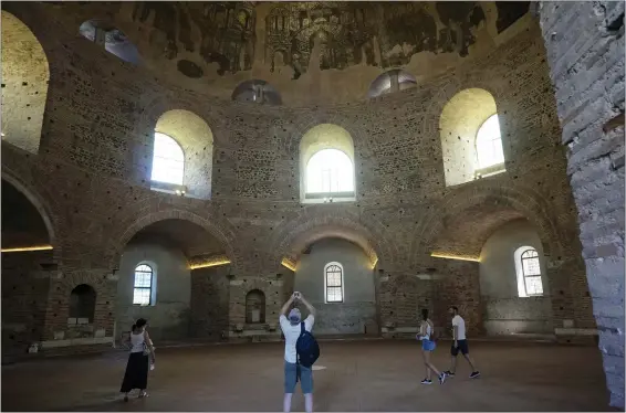  ?? GIOVANNA DELL’ORTO — THE ASSOCIATED PRESS ?? Visitors admire the Byzantine mosaics adorning the gigantic dome of the Rotunda in Thessaloni­ki, Greece. The circular building was built as a Roman temple or mausoleum in the 300s, shortly after became a Christian church, later on a mosque – and is now a museum, though liturgy is still celebrated a few times a year.