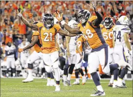  ?? AP ?? Denver’s Shaquil Barrett (48) and Aqib Talib celebrate after teammate Shelby Harris blocked a Chargers field goal attempt with one second left to clinch a 24-21 victory.