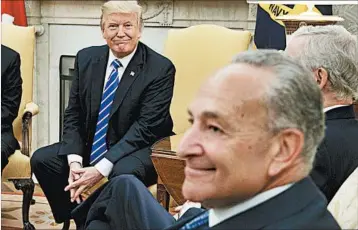  ?? EVAN VUCCI/AP ?? Top Senate Democrat Chuck Schumer, right, seen with President Donald Trump, dined Wednesday at the White House.