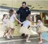  ?? ALLYN DIVITO John Hopkins All Children’s Hospital/AP ?? In 2018, security guard David Dean danced with the girls at John Hopkins All Children’s Hospital in St. Petersburg, Fla.