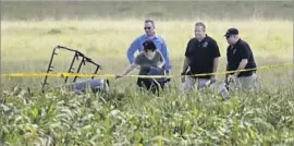  ??  ?? THE PARTIAL frame of the balloon is visible in the field. A federal investigat­ion will begin “full bore” once the team of experts arrives in central Texas.