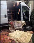  ?? Photo courtesy MARNI JAMESON ?? Turkish rug merchant Hakan Zor stands in his rug-filled van, which he drives to clients’ homes all over the United States to help them choose rugs.