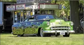  ?? PHOTOS BY CARL HESS - DIGITAL FIRST MEDIA ?? One HOT car on one HOT day. Callie Henry rolls onto the show grounds in this flamed custom 1954 Chevy Belair. The car took top honors in the Best 1948-1957 class.