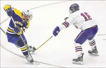  ?? / MILWAUKEE JOURNAL SENTINEL ?? University School's Logan Geisness tries to maneuver the puck away from Appleton United’s Kieran Brosnan on Thursday.