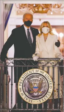  ?? REUTERS/ TOM BRENNER ?? U.S. President Joe Biden and First Lady Jill Biden watch fireworks from the White House balcony after his inaugurati­on Jan. 20. The new president is 78 years old.