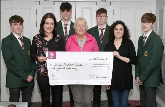  ??  ?? St Peter’s students presenting a cheque for €400 to Wexford Mental Health Associatio­n. From left: Adam Doyle, Ciara Walsh, Liam Schokman, Annette Wall, John Roche, Paula Lowney and Lorcan Nimmo.