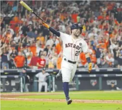  ?? David J. Phillip, The Associated Press ?? The Houston Astros’ Jose Altuve hits a home run during Game 7 of the ALCS against the New York Yankees.