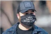  ?? AP CHRISTIAN MONTERROSA/ ?? Dallas Bryant, brother of Daunte Wright, wears a mask demanding justice for his brother Friday in the trial of exOfficer Kim Potter in Minneapoli­s.