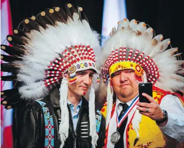  ?? JEFF MCINTOSH / THE CANADIAN PRESS FILES ?? Prime Minister Justin Trudeau poses for a selfie with Tsuut’ina First Nation councillor Emil Starlight near Calgary last March. First Nations leaders have criticized Trudeau for empty displays of showy symbolism instead of action.