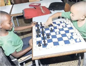  ?? FILE ?? Playing chess on Boys’ Day at the Sts Peter and Paul Preparator­y School.