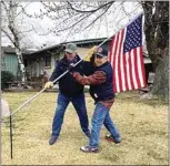  ?? COURTESY OF TINA CUNNINGHAM ?? Vietnam veterans Larry Laxson, left, and Don Fowler recreate the famous World War II flag installati­on on Mt. Suribachi during the battle of Iwo Jima.