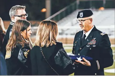  ?? Andy Baxter, File ?? The Pierson family was presented with a flag in honor of Trey Pierson’s service to his country.