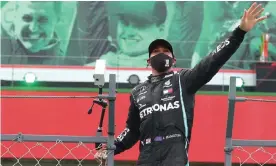  ??  ?? Lewis Hamilton waves to the spectators after winning the Portuguese Grand Prix, with the image of Michael Schumacher (top left) in the background. Photograph: José Sena Goulão/ AFP/Getty Images