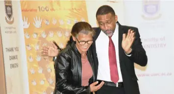  ??  ?? BENEFICIAR­Y Mavis Davids shares a light-hearted moment with Dr Emile Prince, deputy dean of clinical at the UWC Dentistry Faculty, who initiated the 100 dentures project.