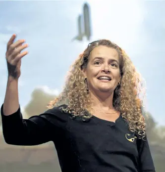 ?? PAUL CHIASSON/THE CANADIAN PRESS ?? Canadian astronaut Julie Payette describes her mission to the Internatio­nal Space Station with a photograph in the background of the space shuttle with her in it during lift off in 2009 in Longueuil, Que. The former astronaut will be Canada’s next...