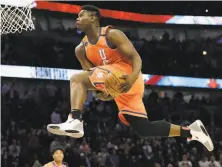  ?? Nam Y. Huh / Associated Press ?? Team USA forward Zion Williamson, of the Pelicans, goes up for a dunk against the World Team in the second half.