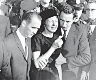  ??  ?? In this Nov. 25, 1963, file photo, Marie Tippit, widow of police officer J.D. Tippit, who was slain during the search for President John F. Kennedy’s assassin, is led weeping from Beckley Hills Baptist Church in Dallas after funeral services for her...