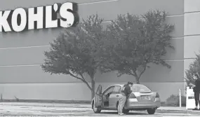  ?? MARK HOFFMAN/MILWAUKEE JOURNAL ?? A store associate delivers a purchase to a drive-up customer Tuesday at the Kohl's store in Fond du Lac. The coronaviru­s and store closures cut Kohl's Corp. sales by 43.5% in the first three months of 2020 compared to the same period last year.