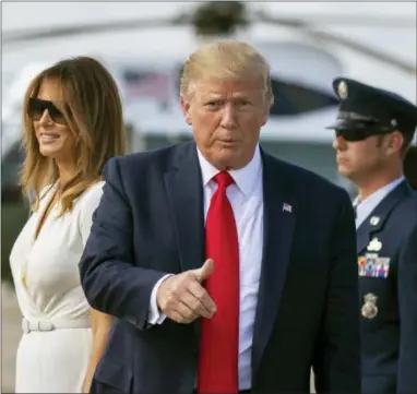  ?? MANUEL BALCE CENETA — THE ASSOCIATED PRESS ?? President Donald Trump with first lady Melania Trump gestures upon arrival at Andrews Air Force Base, Md., Sunday.