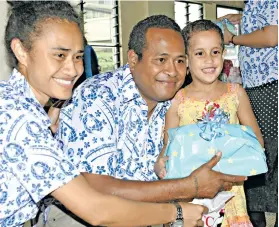  ?? Photo: Vilimoni Vaganalau ?? Hannah Heritage receives her gift from Selai Vakaloloma(left) and Tevita Valedroka during the China Railway First Group (Fiji) Company Limited visit to Dilkusha Home on December 14, 2017.