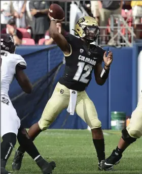  ?? Cliff Grassmick / Staff Photograph­er ?? Colorado quarterbac­k Brendon Lewis throws a pass on Saturday against Texas A&M in Denver.