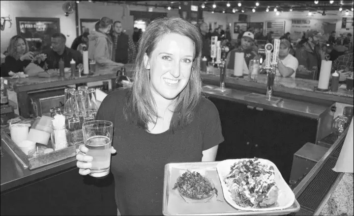  ?? SUBMITTED PHOTOS/STEVE MACNAULL ?? Bartender Brittany Newman brought out our Hot Mess brisket and Peticolas Golden Opportunit­y beer at Dallas’ top barbecue joint, Pecan Lodge.