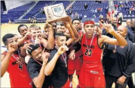  ?? NICK DAGGY / STAFF ?? Wayne’s players celebrate Saturday’s Division I boys basketball district championsh­ip win over Fairfield at Xavier University in Cincinnati.