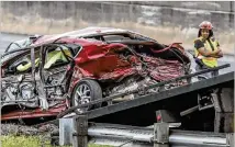  ?? JOHN SPINK / JSPINK@AJC.COM ?? A serious multivehic­le crash shut down I-285 in College Park on Wednesday morning. A red sedan sideswiped a van and then veered into oncoming traffic, where it was hit by a big rig and several other vehicles. The sedan’s driver died.