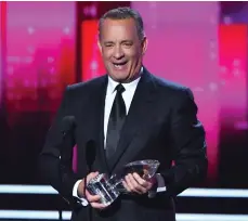  ??  ?? Tom Hanks accepts the award for Favourite Dramatic Movie Actor. The veteran star has won eight previous People’s Choice Awards.