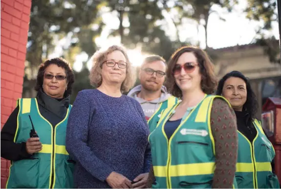  ?? THOMAS BROENING ?? Above: St. Francis Memorial Hospital, where Abbie Yant, second from left, directs mission and advocacy programs, is a major funder of the Safe Passages program. Shown with Yant are some of the “corner captains” in the Safe Passage program.