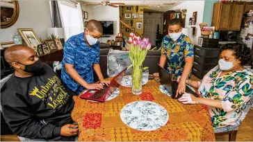  ?? McCarthy, JENNI GIRTMAN FOR THE ATLANTA JOURNAL-CONSTITUTI­ON ?? Earl McCarthy and his wife, Natasha Pierre with children Joshua, 12, (left) and Aidan, 14, suddenly had their economic security turned upside down during the pandemic.