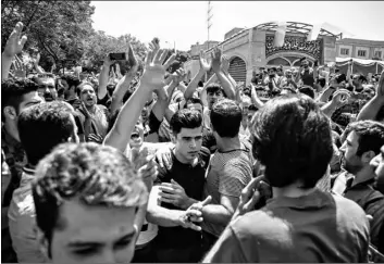  ?? Iranian Labor News Agency via AP ?? In this 2018 file photo, a group of protesters chant slogans at the main gate of the Old Grand Bazaar, in Tehran, Iran.