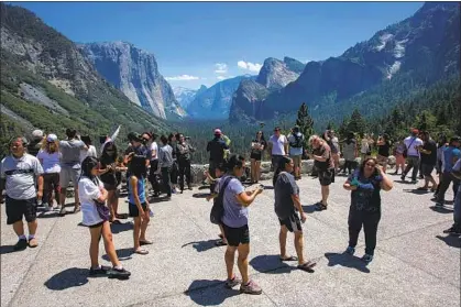  ?? BEFORE THE Brian van der Brug Los Angeles Times ?? pandemic led to crowd-cutting measures, visitors packed Tunnel View lookout in 2017 in Yosemite.