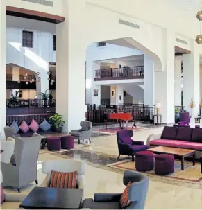  ??  ?? Hotel lounge and atrium at the hotel which offers all-inclusive stays