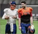  ?? Paul Buckowski / Times Union ?? Albany Empire quarterbac­ks, Warren Smith Jr., left, and Sam Castronova talk during practice on Wednesday.