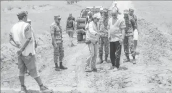  ?? Photo) (Ministry of the Presidency ?? Minister of State, Joseph Harmon (third from right) and members of the reconnaiss­ance team inspect this site along the Karaudanaw­a trail, where works have begun for the constructi­on of a culvert.