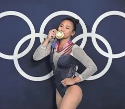  ?? GREGORY BULL/AP ?? Sunisa Lee reacts as she poses for a picture after winning the gold medal in the gymnastics all-around final at the Summer Olympics July 29 in Tokyo.