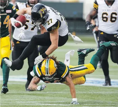  ?? JASON FRANSON/THE CANADIAN PRESS ?? Hamilton Tiger-cats running back Mercer Timmis had a breakout game against Aaron Grymes and the Edmonton Eskimos Friday, rushing for 133 yards and two touchdowns.