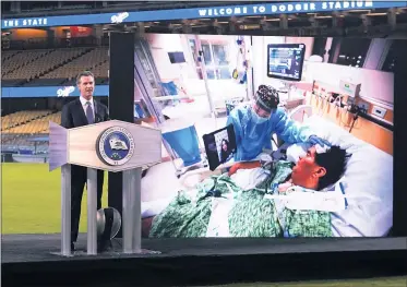  ?? KEITH BIRMINGHAM — STAFF PHOTOGRAPH­ER ?? Gov. Gavin Newsom speaks about the COVID-19 pandemic during his State of the State address from Dodger Stadium on Tuesday. He used the speech to thank California­ns for their sacrifices and tout how the vaccine rollout will end the pandemic.