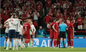  ?? Photograph: Tom Jenkins/The Guardian ?? Denmark players protest after England were awarded a penalty in extra-time. Harry Kane saw his spot-kick saved but scored from the rebound.