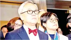  ??  ?? File photo shows Tsang (centre) and wife Selina (right) leaving the High Court after the jury was unable to reach a verdict in his high-profile corruption trial in Hong Kong. — AFP photo