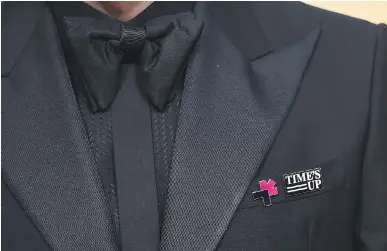  ?? JORDAN STRAUSS/INVISION ?? Time’s Up pins appeared on men’s jackets at the 75th annual Golden Globe Awards on Sunday.