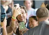  ?? JOE RAEDLE/GETTY ?? Florida Gov. Ron DeSantis greets people during an event spotlighti­ng his newly released book at the Orange County Choppers Road House & Museum on March 8 in Pinellas Park, Florida.