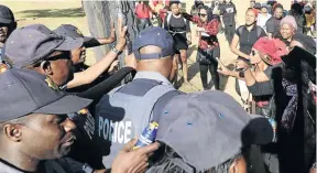  ??  ?? Tension broke out at the Union Buildings as women marchers tried to push their way through police at the gates.