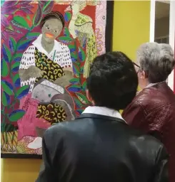  ??  ?? GUESTS at the 2019 Innibos National Craft Awards’ prize-giving delight in the detail of one of the joint first prize entries, Kaross’ Sitting Under the Mango Trees.